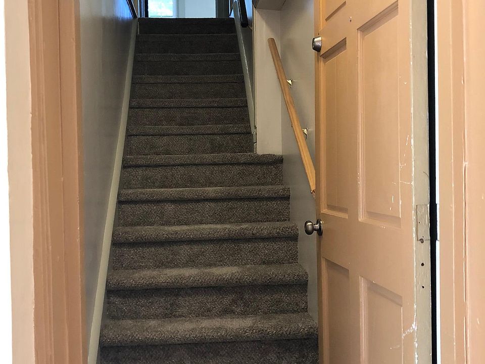 Private staircase with second locking door for security, opening off foyer.