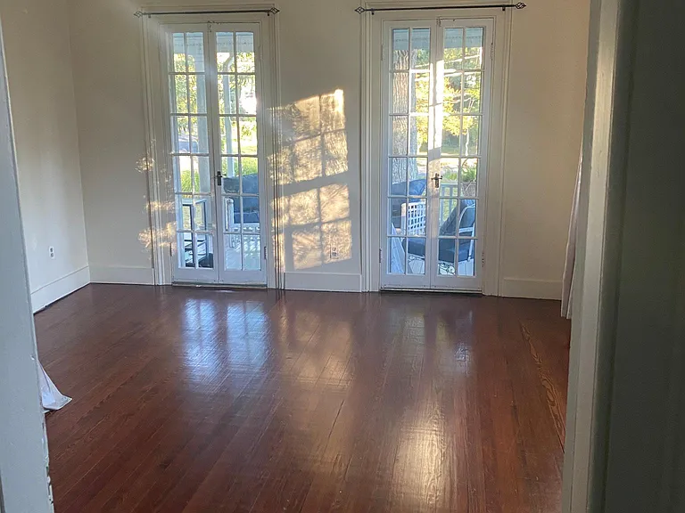 Bedroom with hardwoord floors.