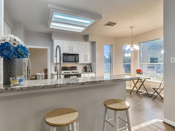 Exotic Italian granite, custom backsplash and fresh paint on the cabinets along with a huge sink and new faucet add in a water filtration system and this kitchen is a dream to be in