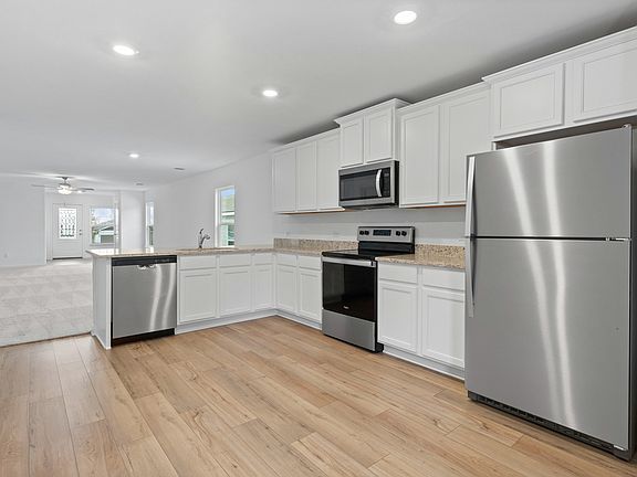 The kitchen includes granite countertops and stainless steel appliances.