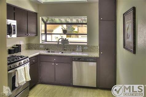 Remodeled kitchen with granite counters and new stainless appliances.