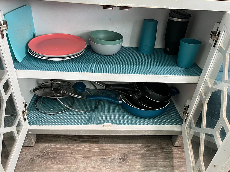 Cabinet contains basic cookware and utensels
