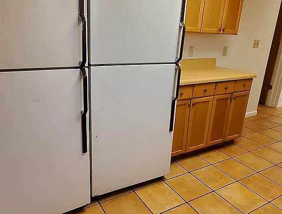 kitchen area. 2 refrigerators