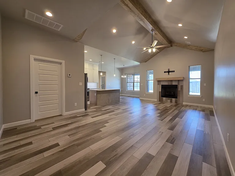 Vaulted & Beamed ceiling with lighted ceiling fan