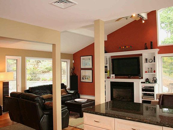 Family room, lake + pool view  The family room + and kitchen open to the pool.