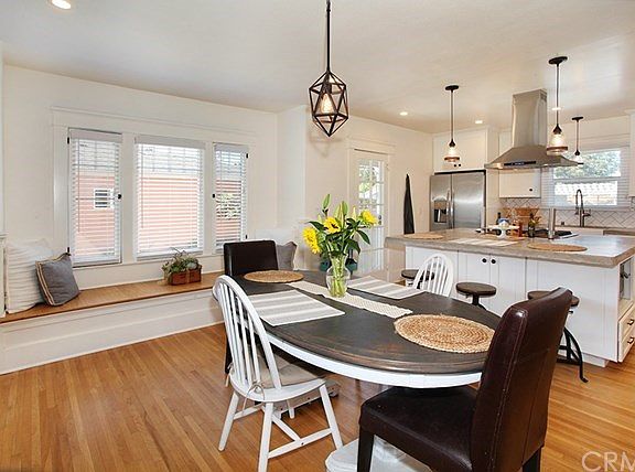 Open floor plan with gorgeous view of new center island and original floors. (Don't miss the microwave hiding on the right side 