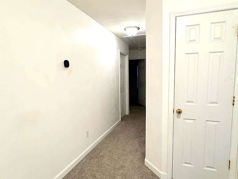 Upstairs hallway to bedrooms and door to linen closet