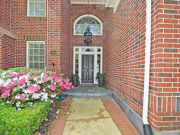A beautiful, covered slate porch, beautifully detailed brick and updated lighting welcomes you in.