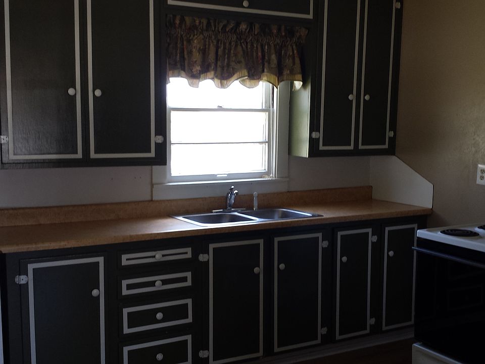 Kitchen with dark green cabinets