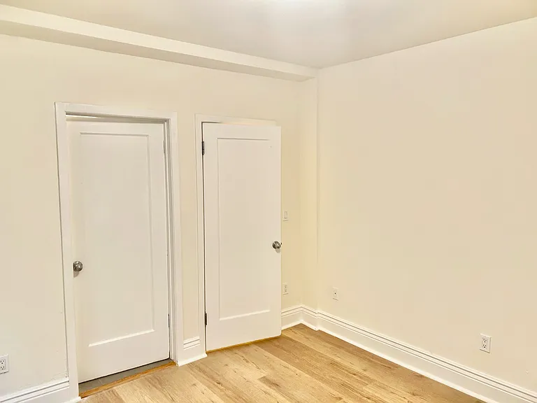 bedroom, left is bathroom door and right is closet door