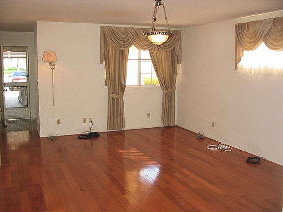 Living room empty facing window and garage door