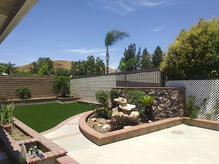 Back yard artificial turf. Plenty of space for table and chairs.