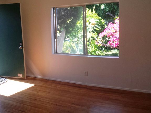 Living room overlooking large front yard and lush garden.