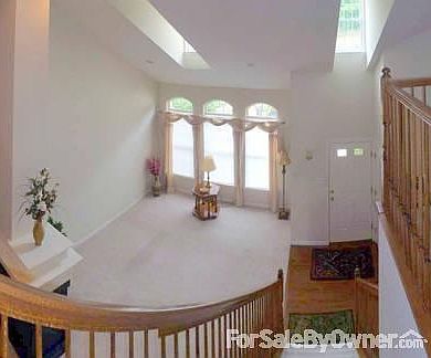 Entry and Living Room
						:
						Windows and dormers provide abundant light into the foyer and living room.