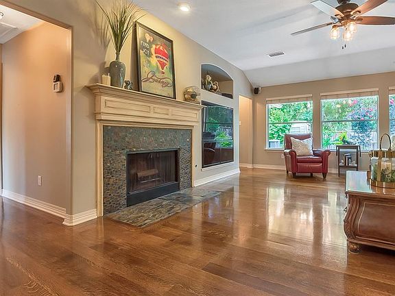Beautiful Quarter Sawn Oak (Tiger Oak) wood floors in the Family Room are warm and inviting. Fireplace has slate tile surround and gas connections. Open and airy with views to pool, vaulted ceiling, updated lighting and ceiling fan.