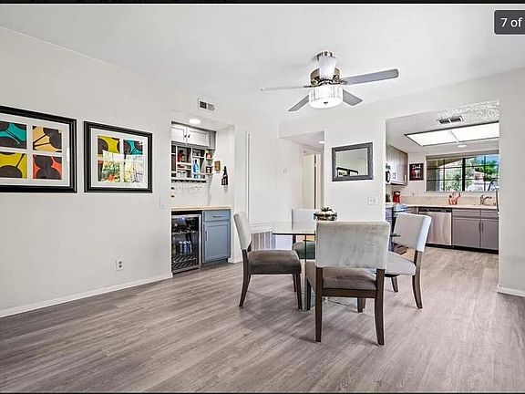 Entry pictured with staged dining area, includes wine cooler and bar storage.