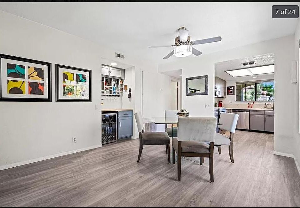 Entry pictured with staged dining area, includes wine cooler and bar storage.