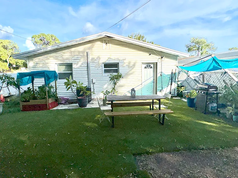 fenced in back yard with large portion of it in artificial grass