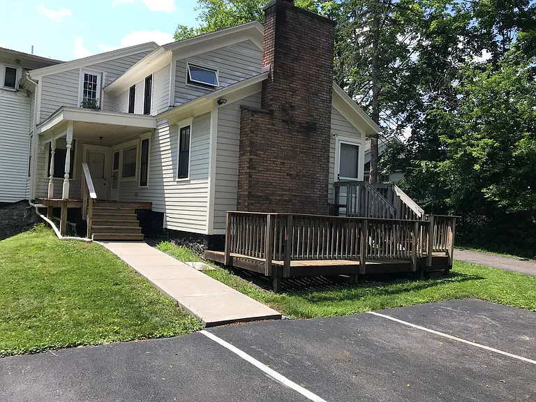 back deck comes with apartment. Can enter apartment through either door. Deck to livingroom or side porch to kitchen
