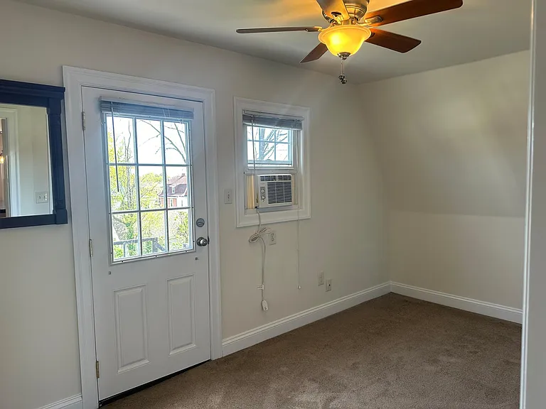 A different angle of bedroom (door leads to fire escape)