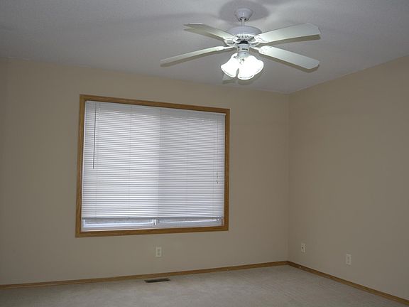Main floor living room with ceiling fan. 