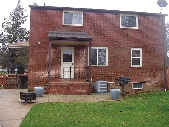 Back yard with patio, fire pit and grill. Steps down to walk out basement.