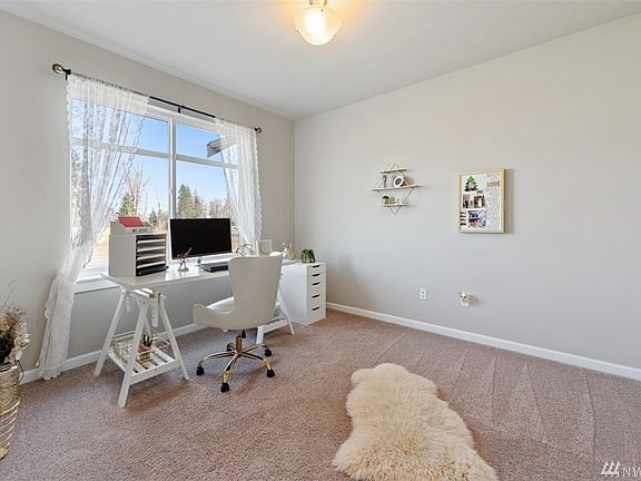 Spacious den looks out towards the front of the home. Enter the den through glass french doors.