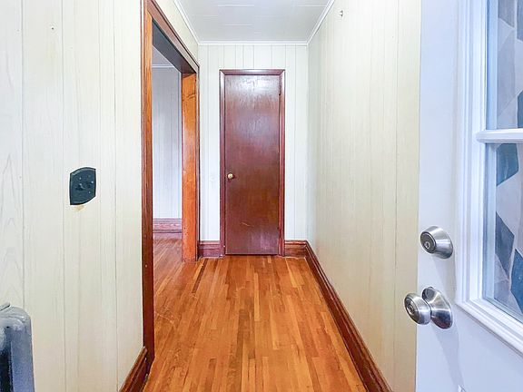 Entry - Hall featuring hardwood / wood-style floors and ornamental molding