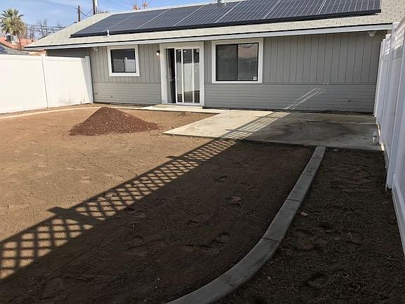Newly fenced yard, landscaping underway