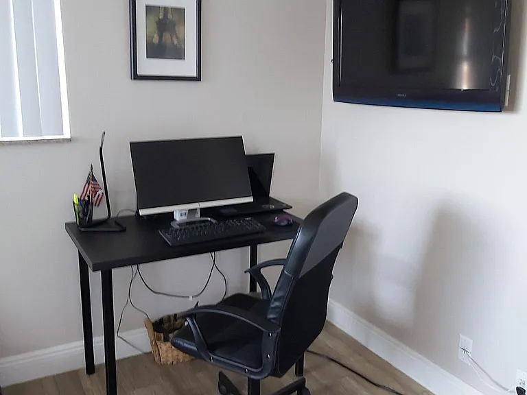 Desk and wall TV inside the bedroom