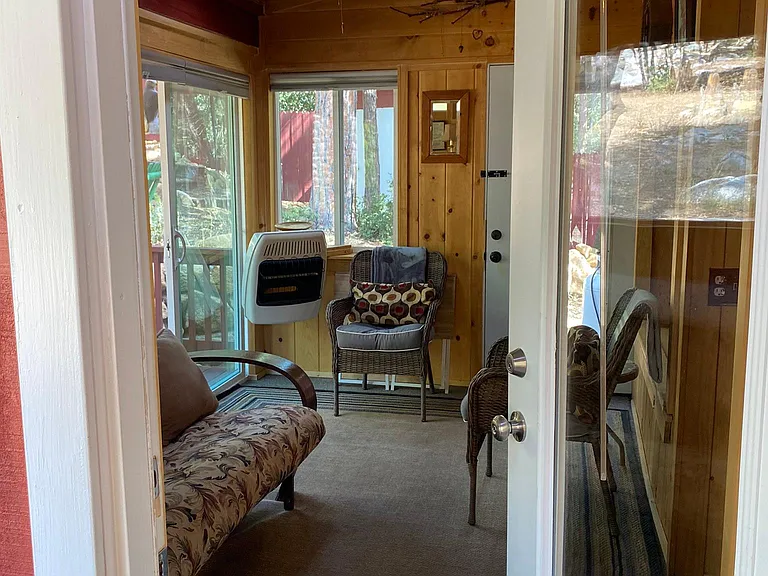 This is the sunroom with a propane heater, a queen futon and two chairs. There is also a collapsible computer table as well.