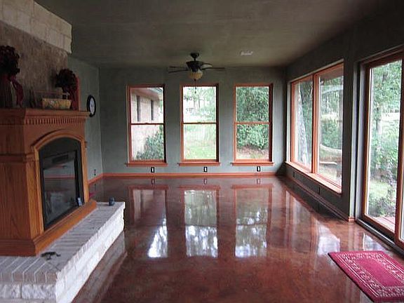 Sun Room With Fireplace and Wall of Windows