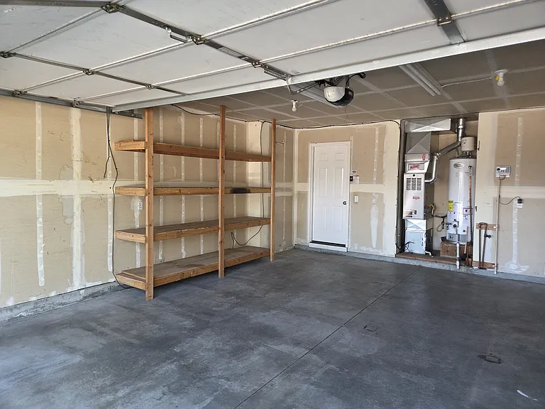 garage with shelves, ample room and great lighting