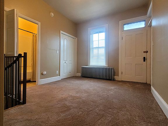 Bedroom featuring walk-in closet, new paint and carpet.