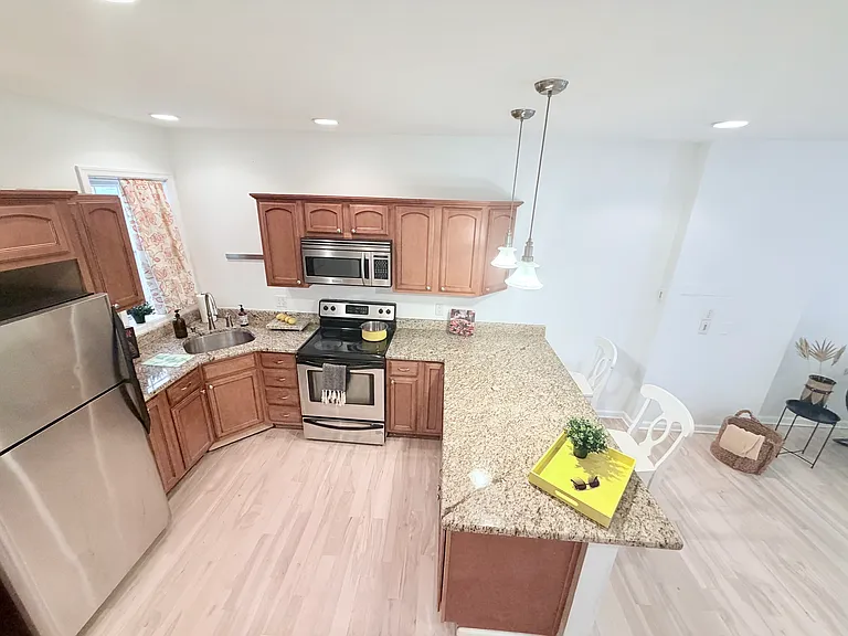Spacious eat in kitchen with stainless steel appliances.