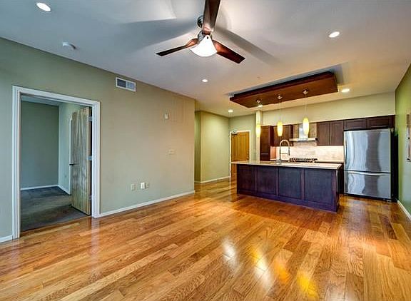 Gleaming wood floors throughout entry, kitchen, living and hallways.  Entry to the master on left.
