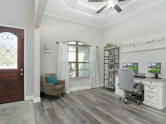 Double tray ceilings accent this home office.