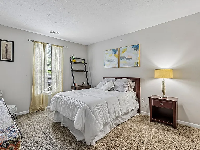 Inviting bedroom with plush carpeting