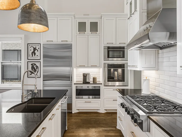 The chef's kitchen boasts a massive island, pantry wall, Wolf steam & convection ovens, a 6-burner 36" gas range and Sub-Zero refrigerator. Everything you need to cook at home, plus island seating and a dining table/room.