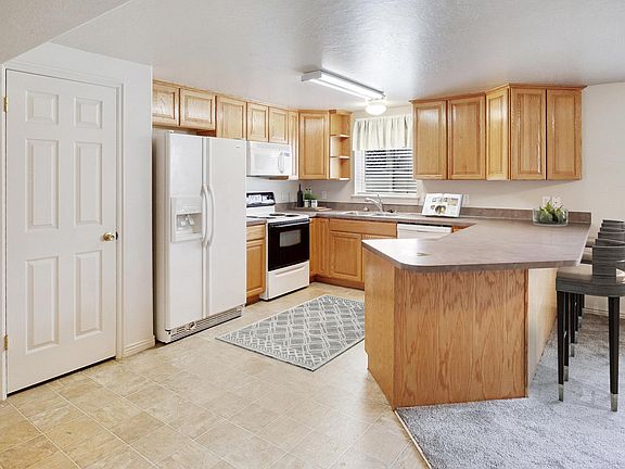 Kitchen area with bar. Large pantry closet door shown.