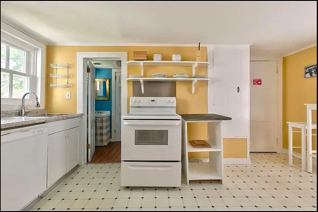 Front view of kitchen, with doorway to second bathroom