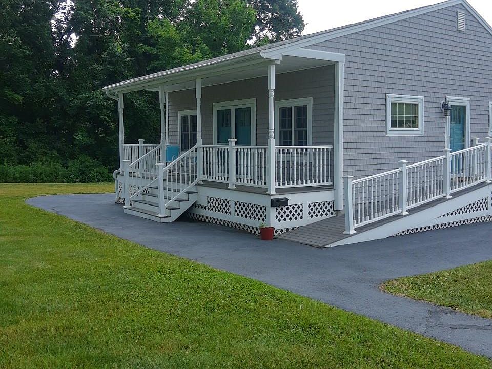 Front porch has double doors and side entry ramp to kitchen