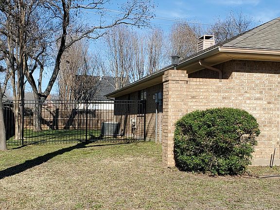Left side of house showing attractive wrought iron fence and gate