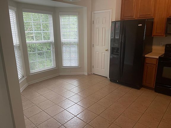 Eat in kitchen with bay window and tile flooring
