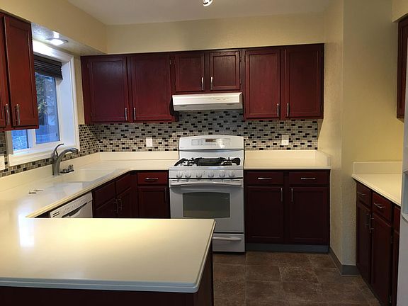Kitchen, new tile backsplash and solid surface counter tops. Range is gas.