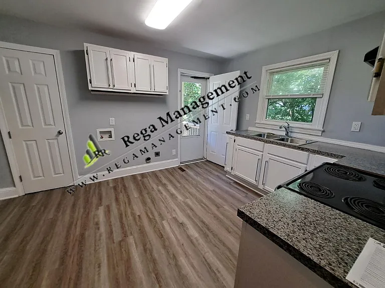 Kitchen with access to back deck area. Refrigerator, Oven and Washer/Dryer Hookups - small pantry