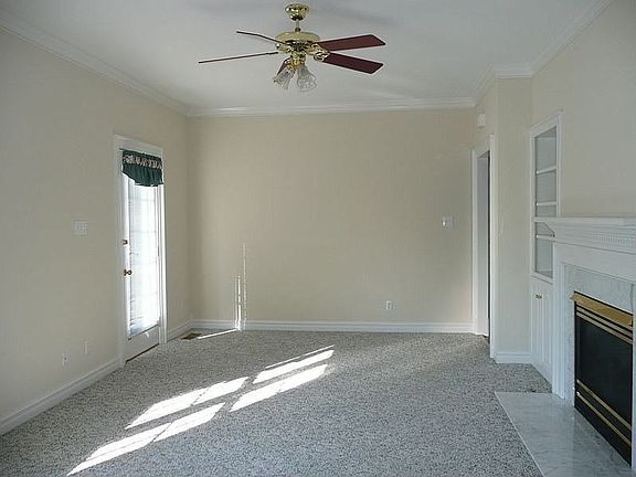 Family Room with Built In Media Closet, Gas Log Fireplace, & Access to Porch
