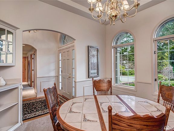 Enjoy elegant dining in your Formal dining room featuring this built-in display cabinet and tray ceilings.