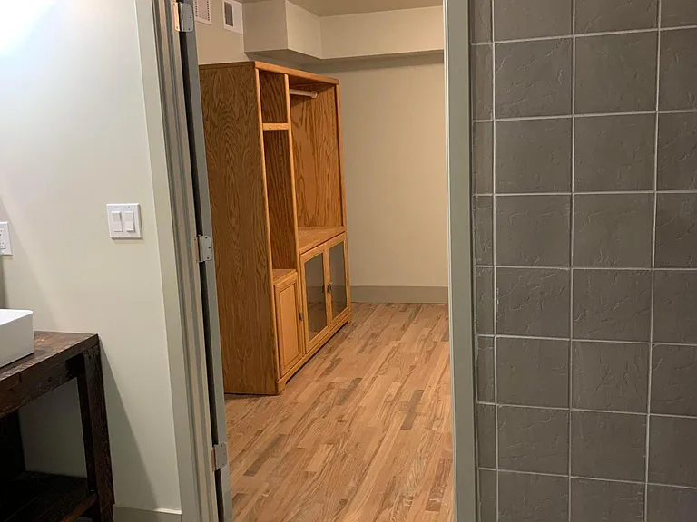 Bedroom with Jack & Jill bathroom; open closet organizers being installed