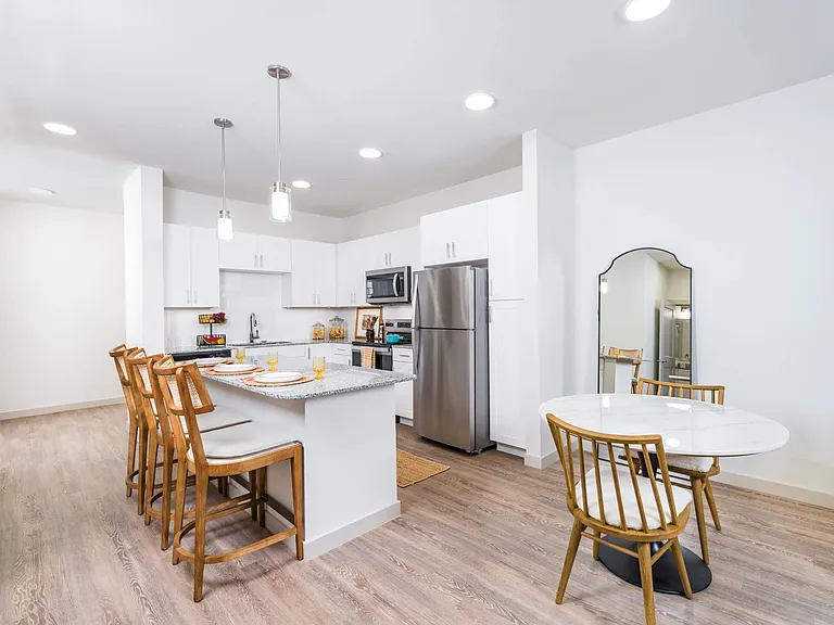 Stylish kitchen with stainless steel appliances and a spacious island perfect for dining and entertaining at Beckett West Fork in Conroe.
